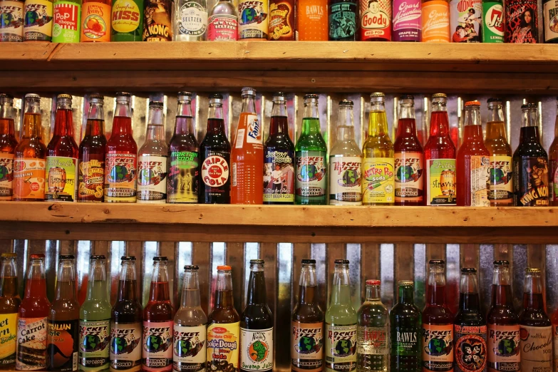 a bunch of bottles that are on a shelf, pexels, pop art, at a 5 0 s diner, a table full of candy, the sour, standing on a shelf