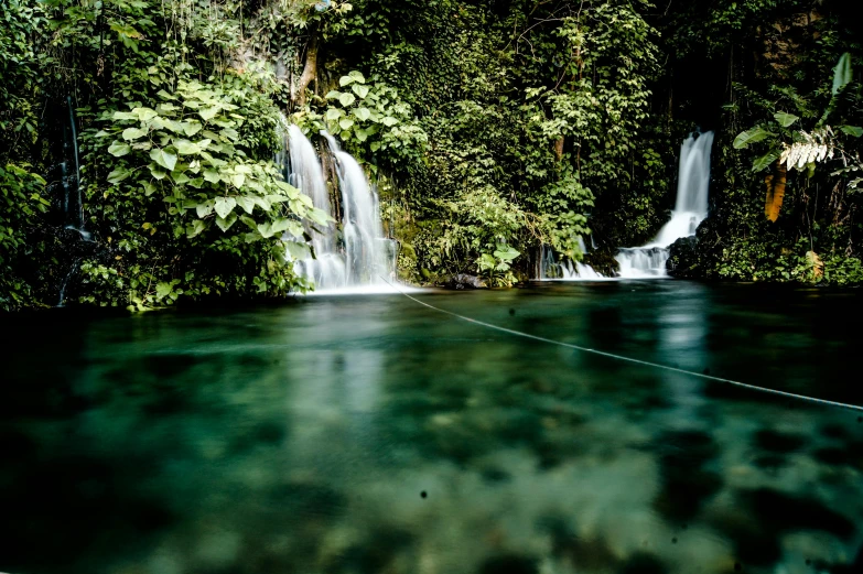 a body of water with a waterfall in the background, pexels contest winner, hurufiyya, philippines, thumbnail, sunken, fishing