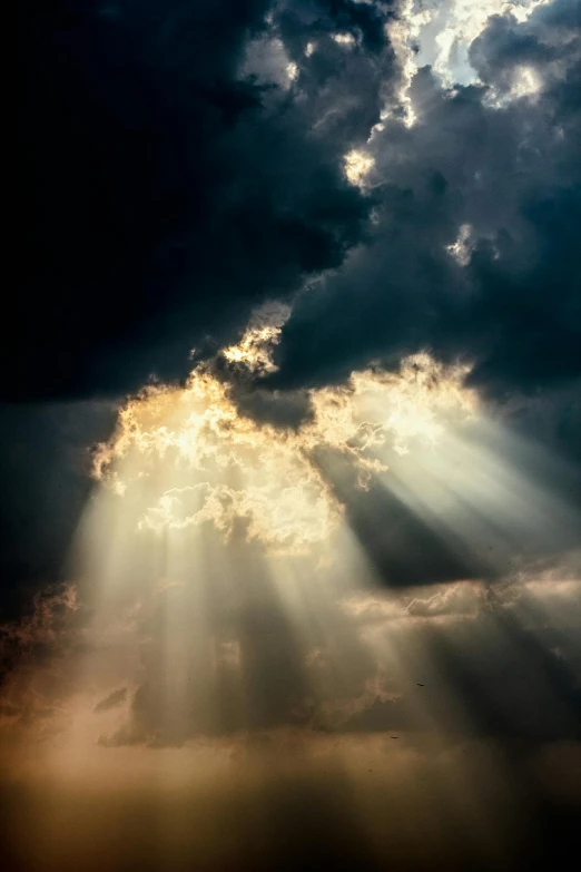 the sun is shining through the clouds, by Robert Storm Petersen, pexels contest winner, light and space, holy lights, dramatic light 8 k, beautiful cinematic light, spotlight from above