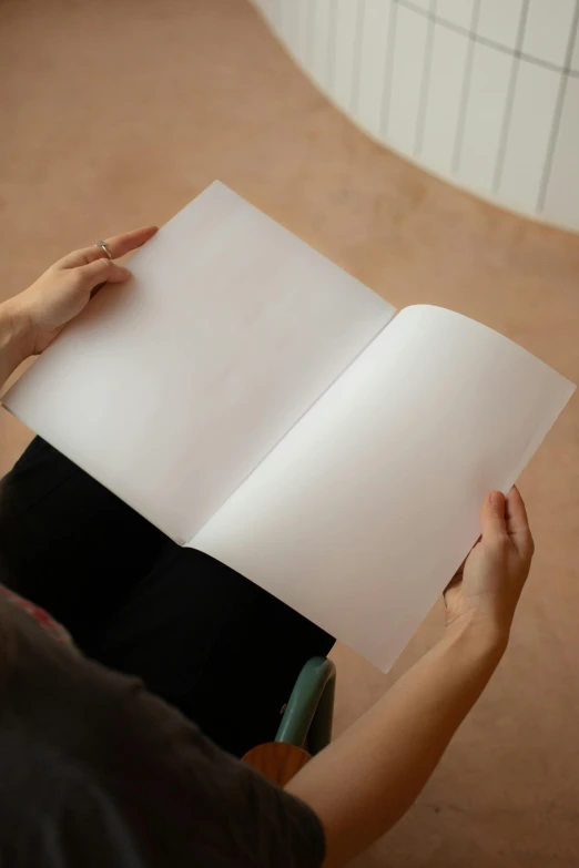 a person sitting on the floor reading a book, private press, soft white rubber, white sketchbook style, thick lining, overview