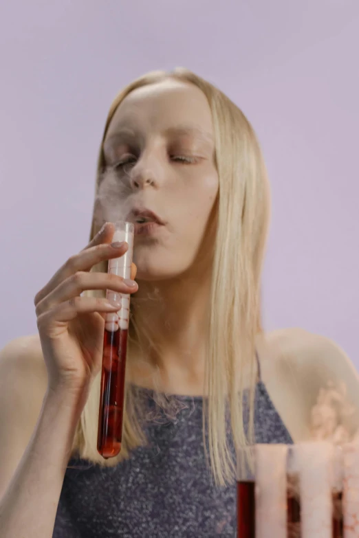 a woman blowing out candles on a birthday cake, an album cover, featured on reddit, aestheticism, from a huge red glass bong, hyper - realistic vfx render, smoke :6, blond