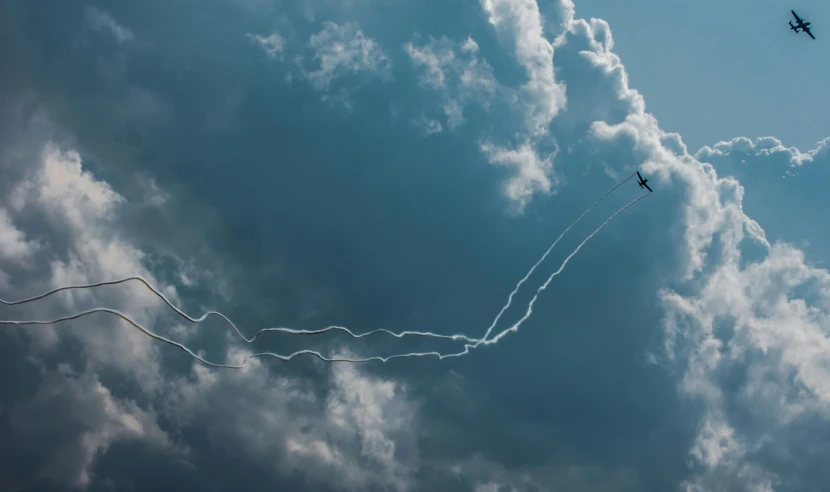 a group of airplanes flying through a cloudy sky, an album cover, by Niko Henrichon, pexels contest winner, precisionism, fork lightning, trail of smoke, profile picture 1024px, cessna glider plane