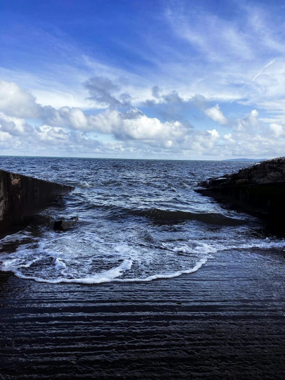 a large body of water next to a rocky shore, happening, maryport, clouds and waves, today\'s featured photograph 4k, 400 steps