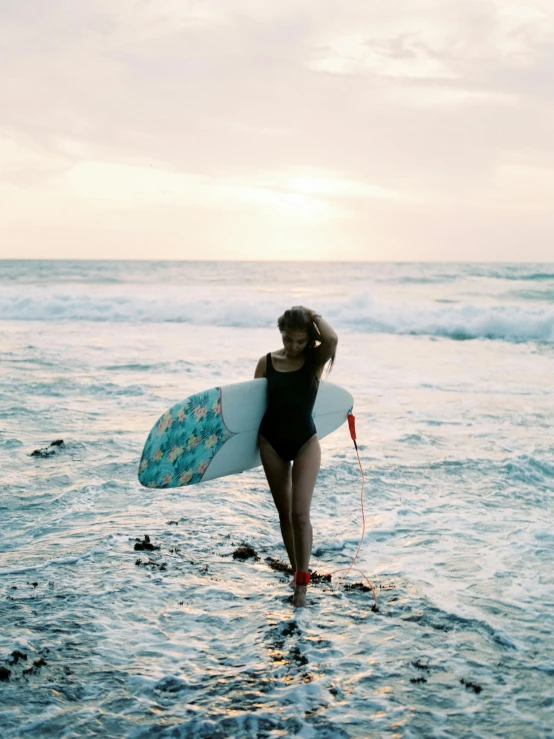 a woman walking into the ocean with a surfboard, pexels contest winner, renaissance, asuka as a surfer model, profile image, wavy, cute girl wearing tank suit