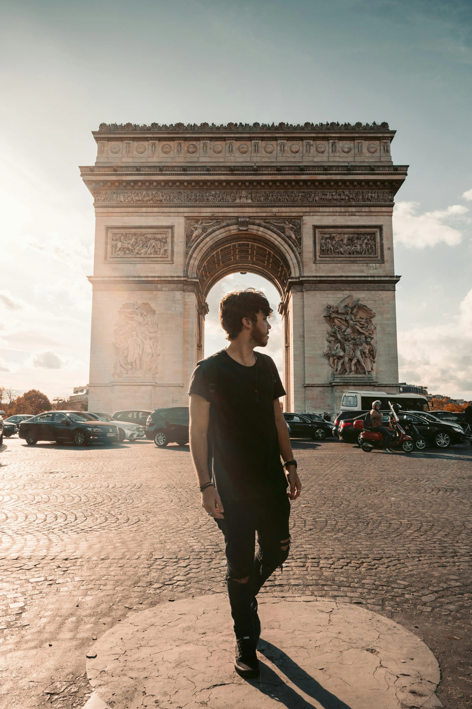 a man standing in front of the arc de trio triumph, an album cover, by Sam Dillemans, pexels contest winner, robert sheehan, walking over a tiny city, french, 🚿🗝📝