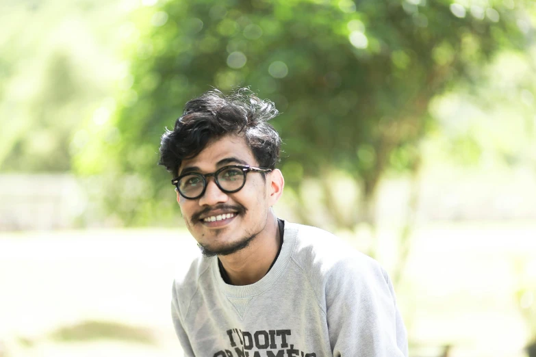 a man that is sitting down with a skateboard, inspired by Bikash Bhattacharjee, hurufiyya, headshot profile picture, cute slightly nerdy smile, in garden, avatar image