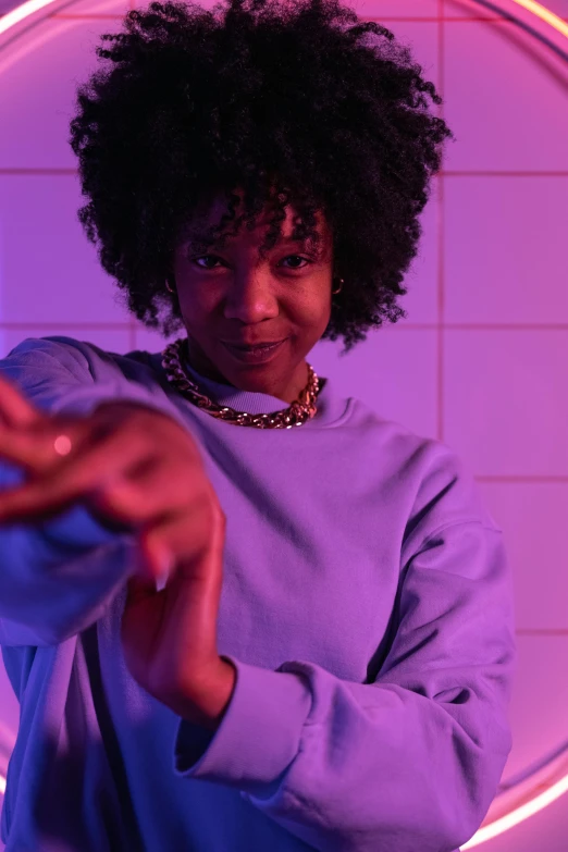 a woman standing in front of a neon circle, trending on unsplash, afrofuturism, wearing a purple sweatsuit, hands reaching for her, soft lighting, sza