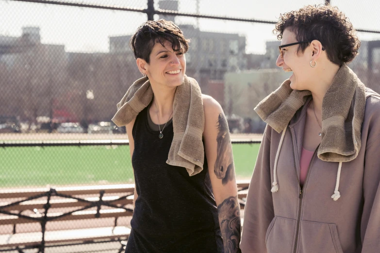 a couple of people standing next to each other, by Nina Hamnett, pexels, lesbian, humans of new york, rebecca sugar, with tattoos