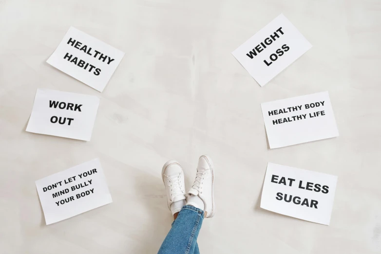 a person standing on top of a white sheet of paper, by Nicolette Macnamara, trending on pexels, placards, healthy, eating, white floor