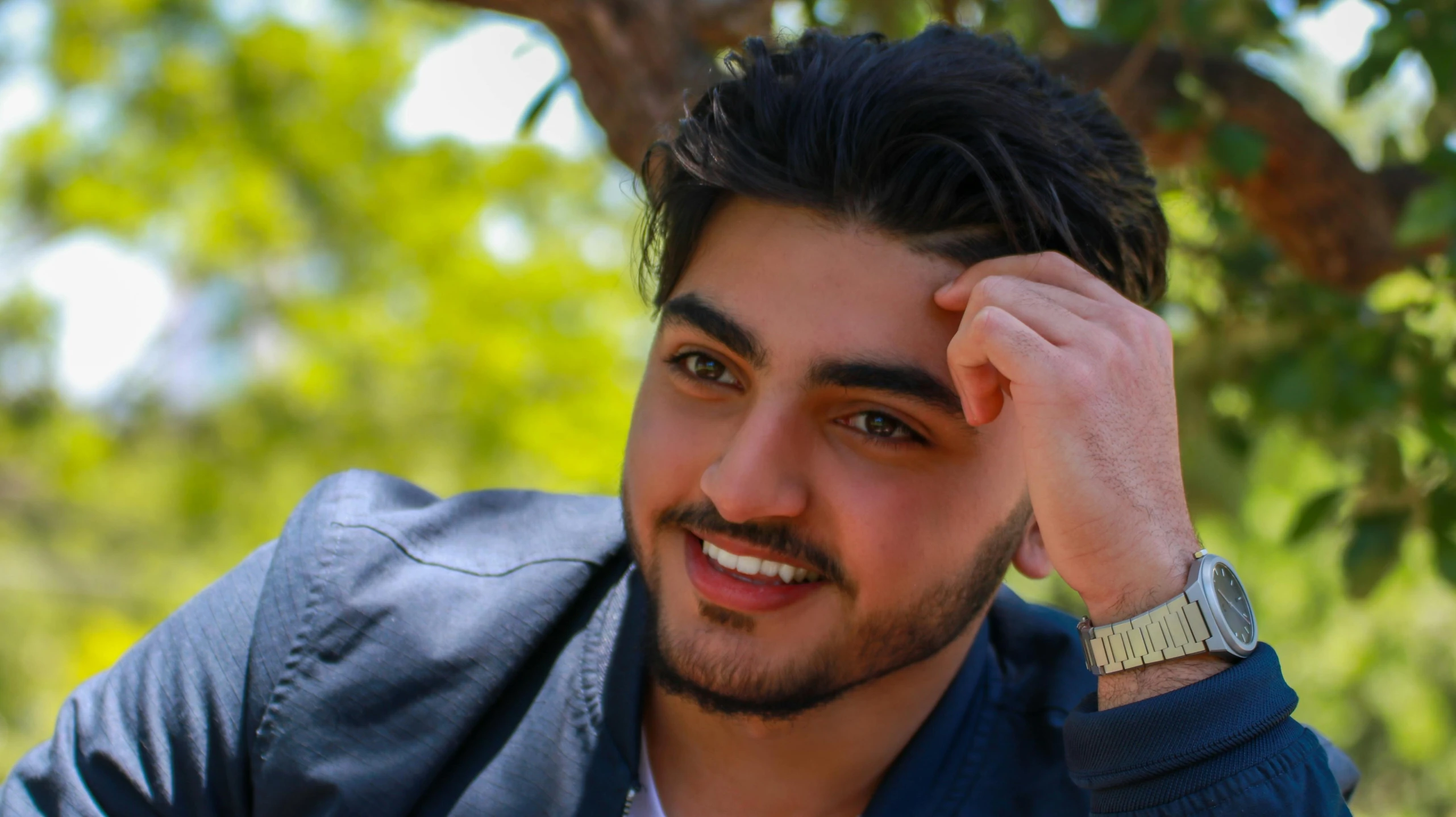 a close up of a person wearing a watch, an album cover, by Ismail Acar, hurufiyya, with a beautifull smile, in sunny weather, assyrian, he is about 20 years old | short
