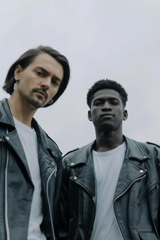 two men in leather jackets standing next to each other, trending on pexels, bauhaus, ( ( dark skin ) ), asya yoranova and alan lee, young handsome pale roma, an all white human