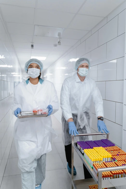 a couple of people walking down a hallway holding trays of food, shutterstock, process art, surgical gear, on a advanced lab, 2 5 6 x 2 5 6 pixels, industries