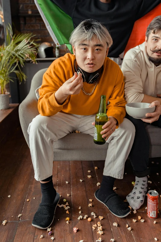 a couple of men sitting on top of a couch, inspired by jeonseok lee, trending on pexels, man drinking beer, snacks, wearing a track suit, asian human