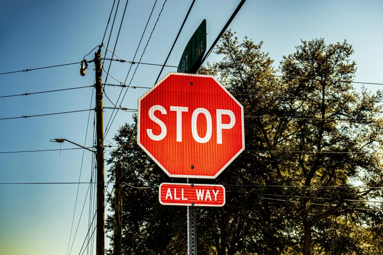 a red stop sign sitting on the side of a road, by Andrew Stevovich, pexels, instagram picture, all at once, in louisiana, bright signage
