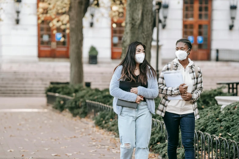 a man and a woman walking down a sidewalk, trending on pexels, happening, masked doctors, high school girls, a wooden, two girls