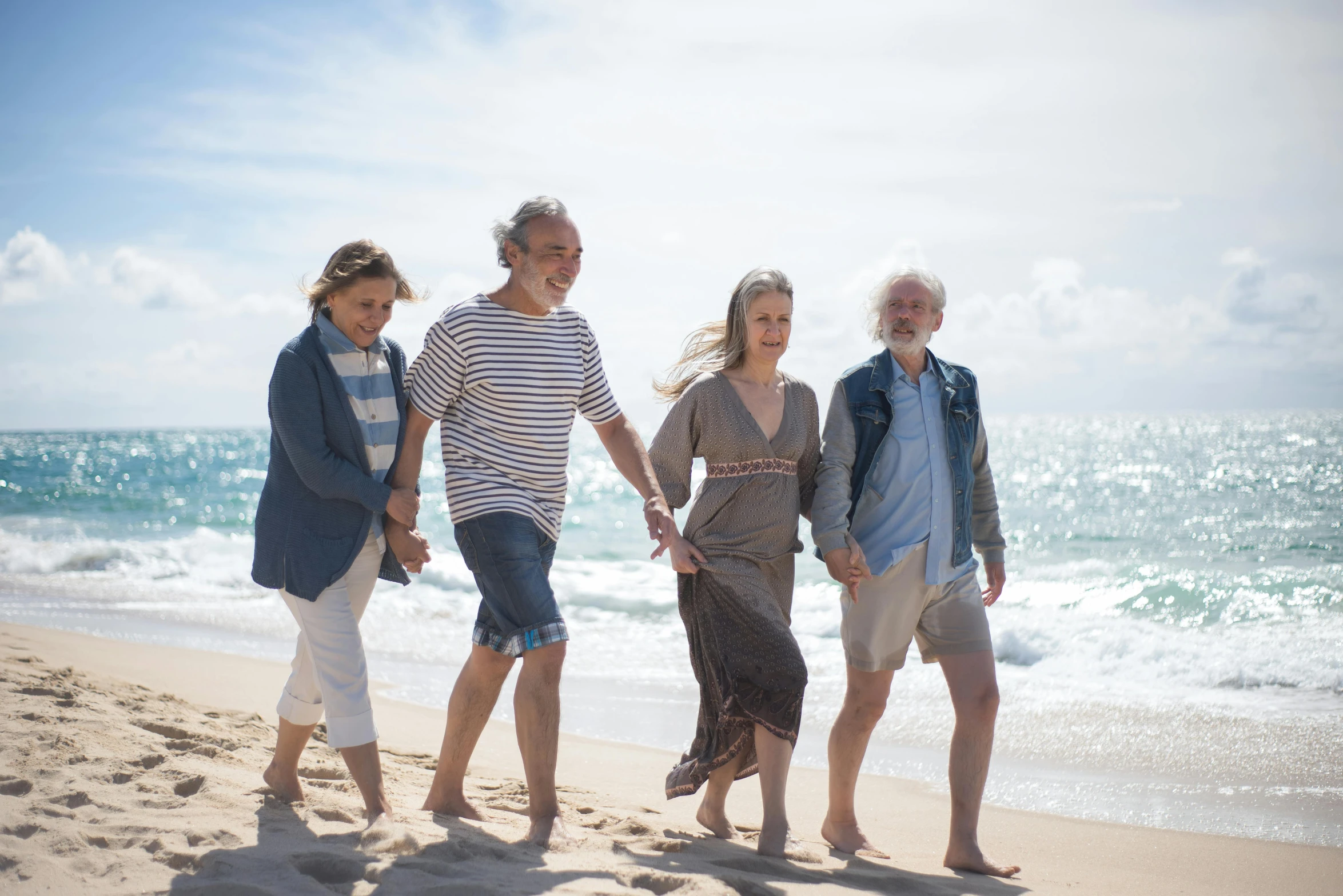 a group of people walking along a beach, elderly, full cast, four seasons, the merge