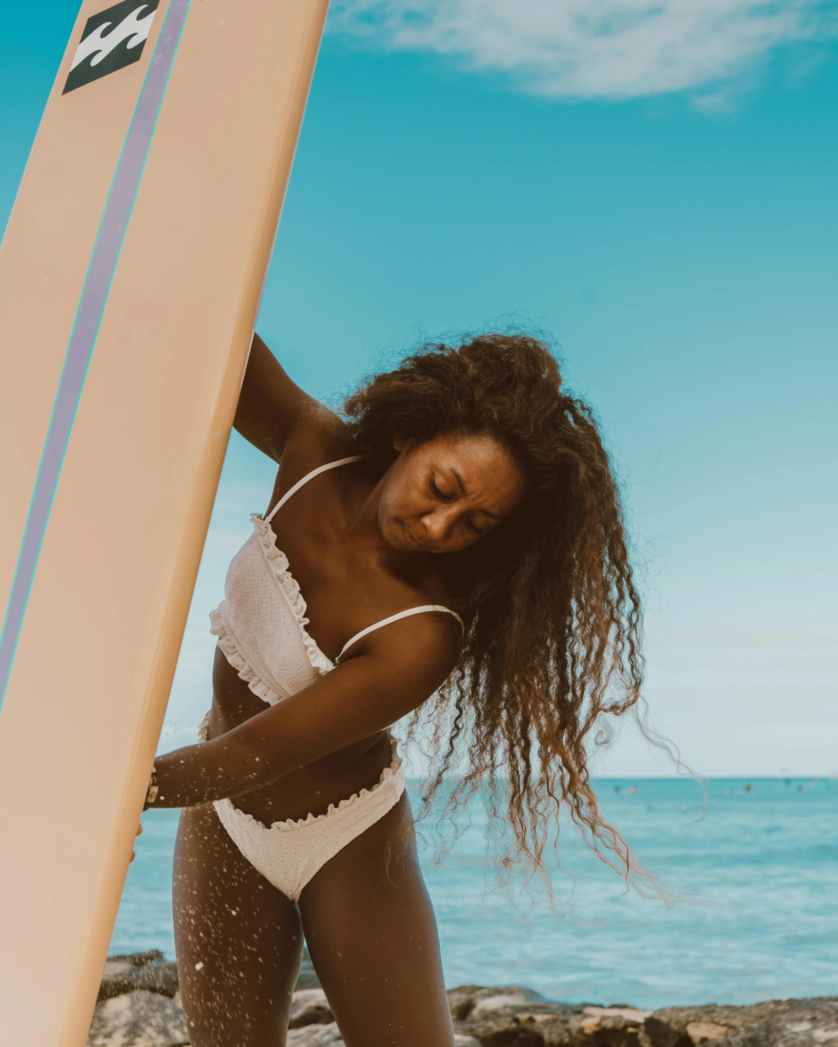 a woman standing on a beach holding a surfboard, by Olivia Peguero, happening, brown skinned, white bikini, on a canva, billboard image