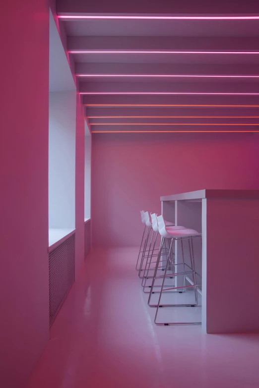 a room that has a bunch of stools in it, inspired by Donald Judd, unsplash contest winner, light and space, fuschia leds, kitchenette and conferenceroom, crown of (pink lasers), dim studio lighting