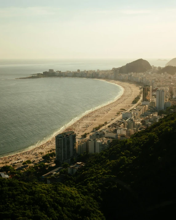 a view of a beach from the top of a hill, by Elsa Bleda, pexels contest winner, graffiti, cristo redentor, lgbtq, joel meyerowitz, aerial view of a city