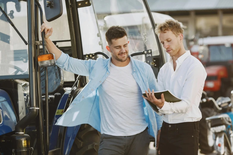 a couple of men standing next to a tractor, pexels, renaissance, worksafe. instagram photo, premium quality, cute scene, white male