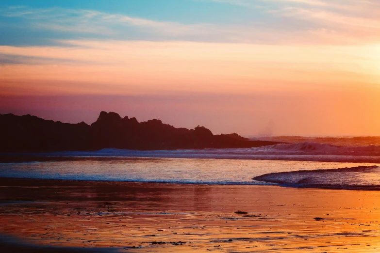 a man riding a surfboard on top of a sandy beach, a picture, unsplash contest winner, romanticism, sunset panorama, pembrokeshire, amazing colours, hollister ranch