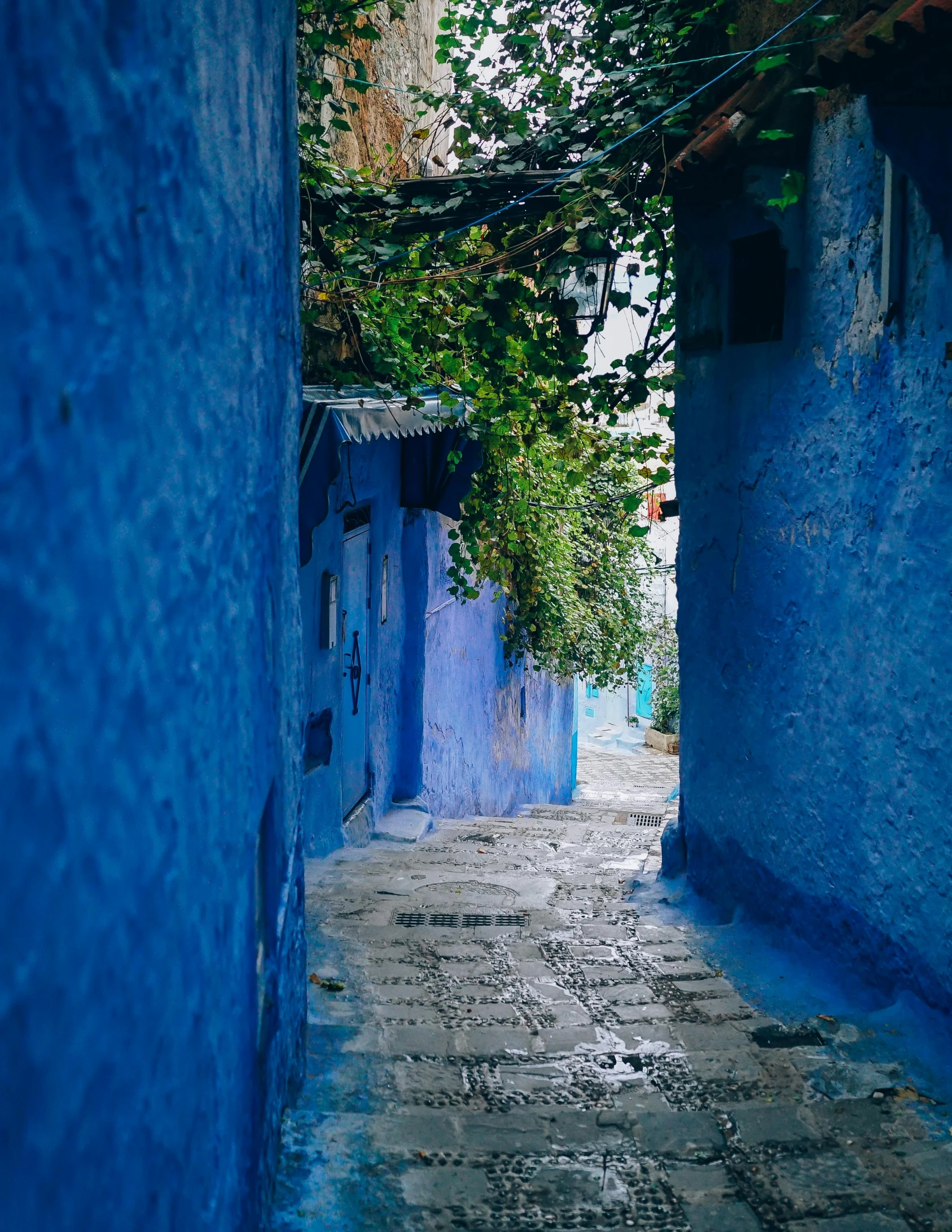 a narrow alley lined with blue painted buildings, a picture, by Julia Pishtar, unsplash contest winner, moorish architecture, promo image, profile image, multiple stories