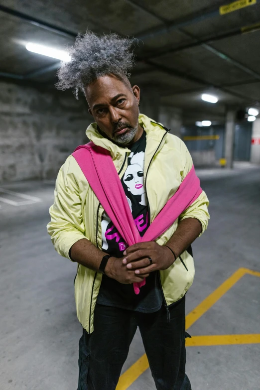 a man with grey hair standing in a parking garage, featured on instagram, happening, coat for a rave, kendrick lamar, in australia, cmyk portrait