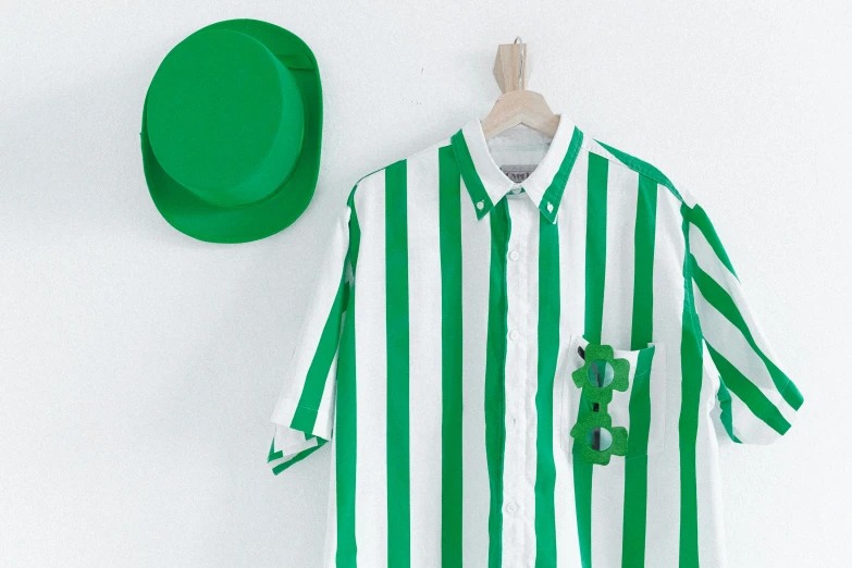 a green and white striped shirt hanging on a wall, inspired by Art Green, with hat, sket - one x iamretro, courtesy of centre pompidou, band merchandise