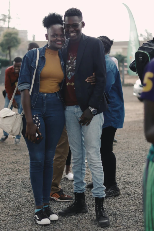 a couple of people standing next to each other, by Ingrida Kadaka, trending on unsplash, afropunk, low quality footage, teenage boy, unmistakably kenyan