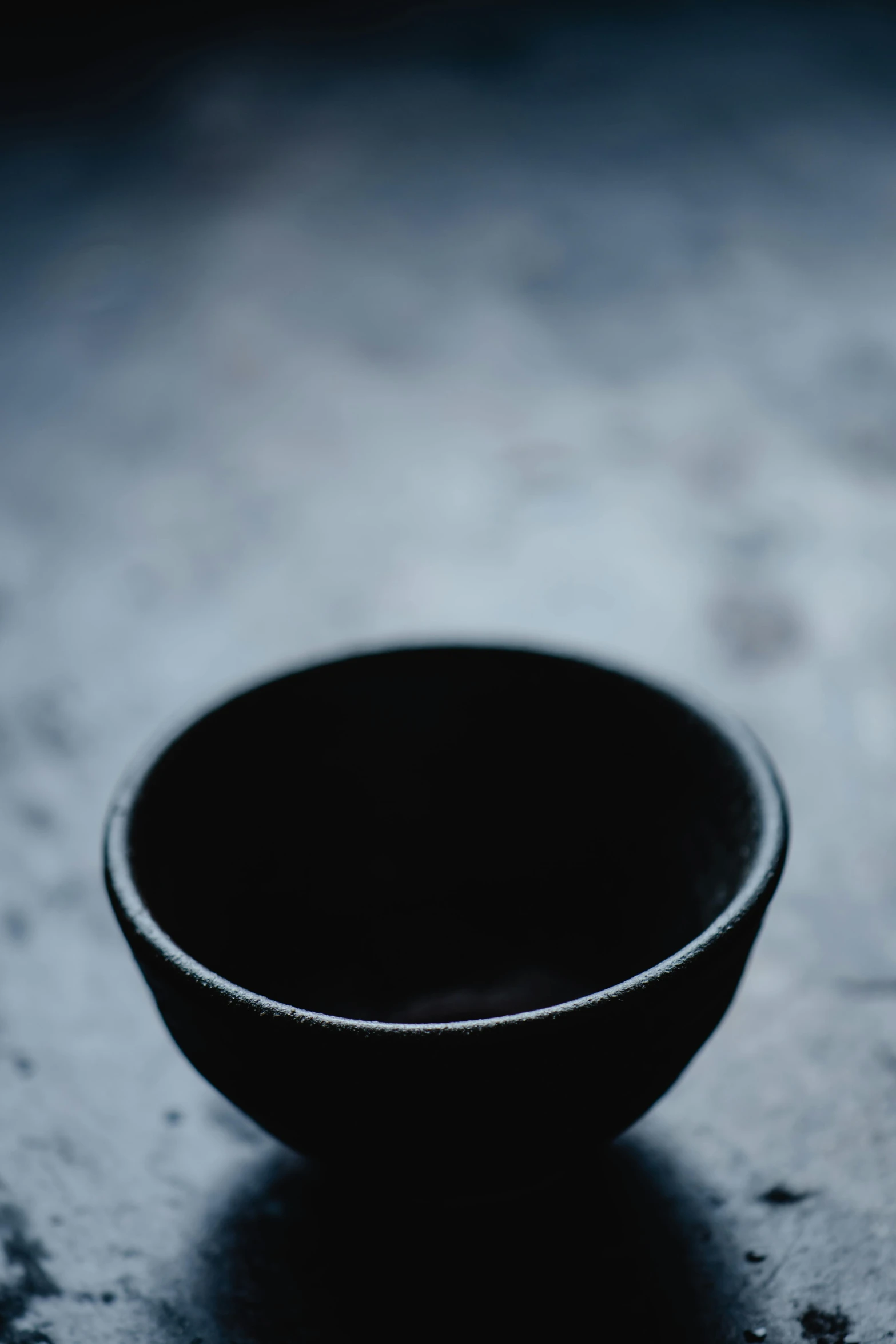 a black bowl sitting on top of a table, unsplash, fine texture detail, drinking, made of glazed, dof wide