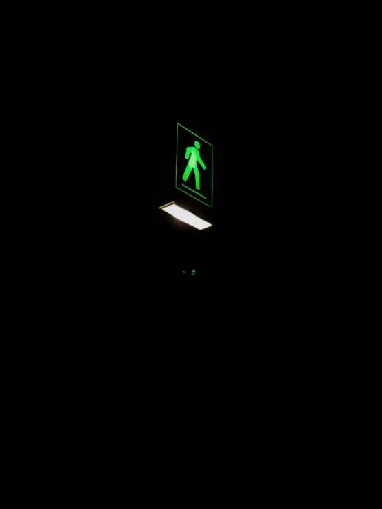 a green crosswalk sign lit up in the dark, unsplash, postminimalism, moonwalker photo, stick figure, light box, against a deep black background