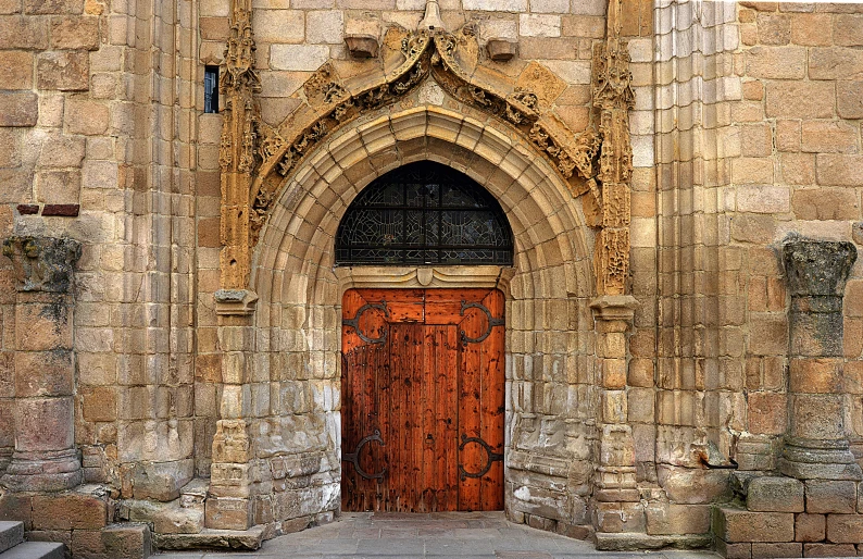 an old stone building with a red door, a photo, by Luis Paret y Alcazar, flickr, romanesque, alabaster gothic cathedral, square, wood door, gothic arch frame