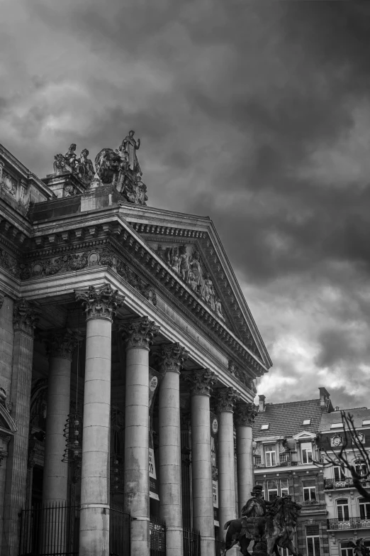 a black and white photo of a building, a black and white photo, pexels contest winner, neoclassicism, storm clouds, market, desaturated colours, square