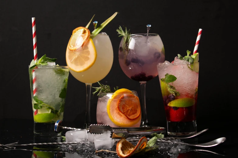 a group of drinks sitting on top of a table, profile image, against dark background, herbs, sparkling water