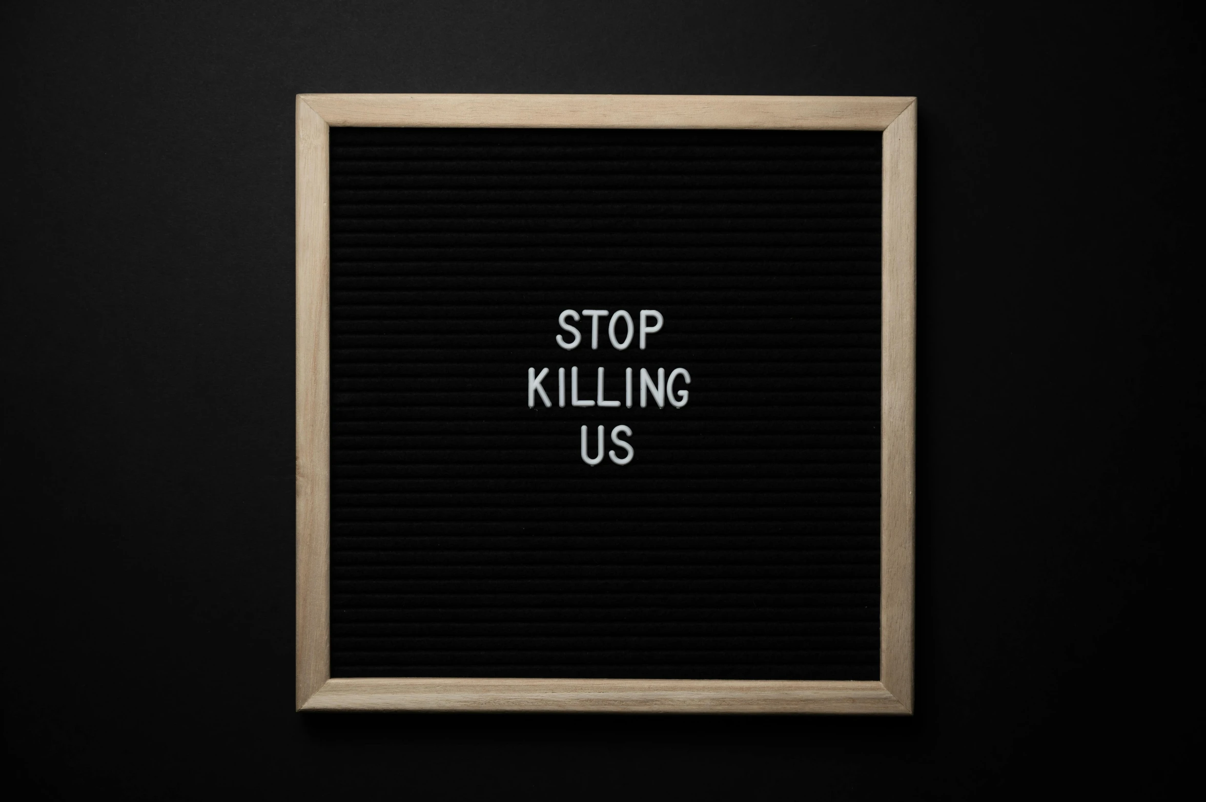 a black board with the words stop killing us written on it, trending on unsplash, it kills you instantly, profile picture 1024px, environmental, murder