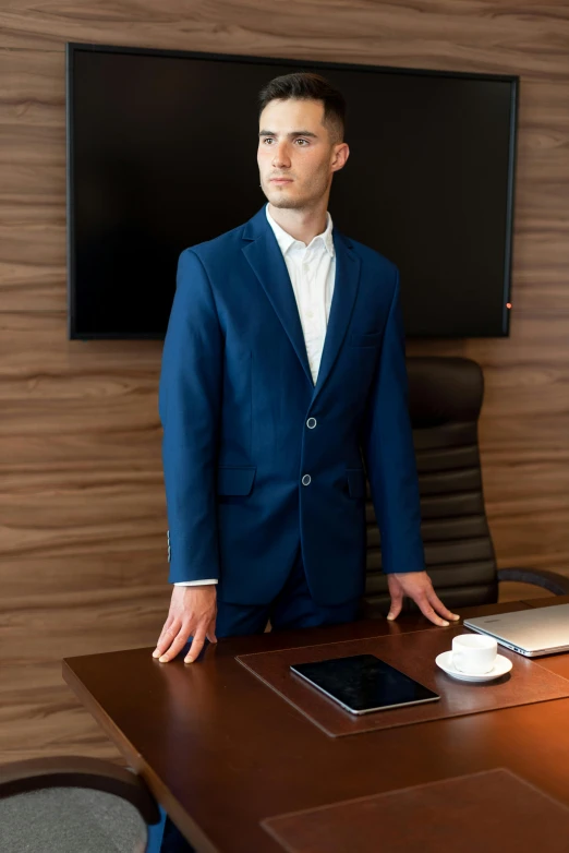 a man in a blue suit standing in front of a desk, extra high resolution, on a desk, high quality product image”