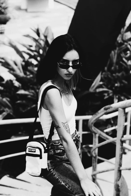 a black and white photo of a woman carrying a surfboard, inspired by Elsa Bleda, tumblr, realism, wearing versace sunglasses, killstar, grunge aesthetic!!!, icon black and white