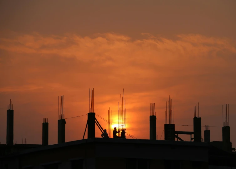 a couple of people standing on top of a building, pexels contest winner, constructivism, ((sunset)), bright construction materials, shot from a distance, silhouette :7