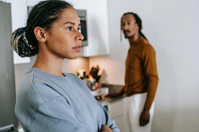 a woman standing next to a man in a kitchen, trending on pexels, wistful expression, profile image, thumbnail