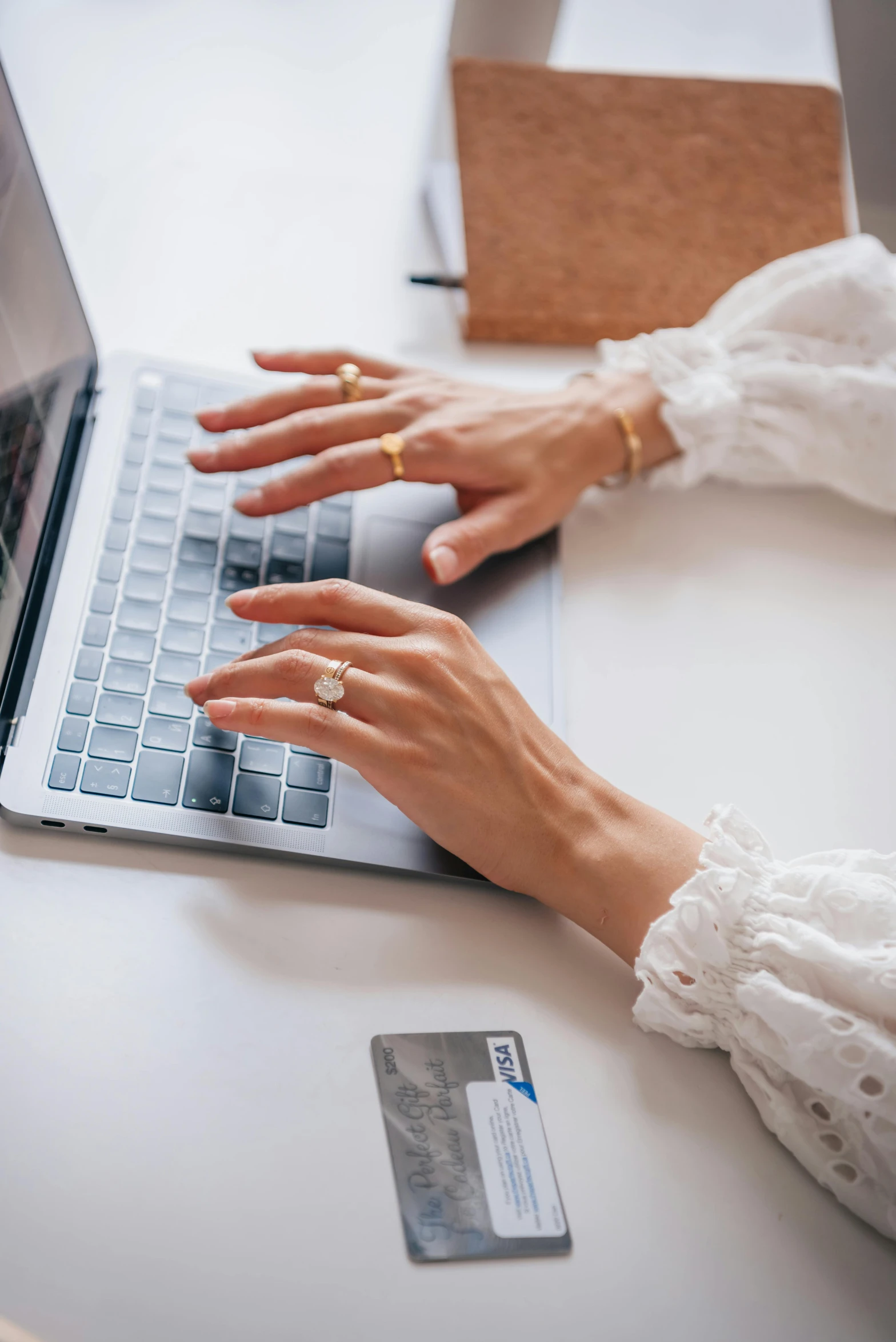 a woman typing on a laptop next to a credit card, trending on pexels, private press, wearing a white button up shirt, thumbnail, high textured, curated collections