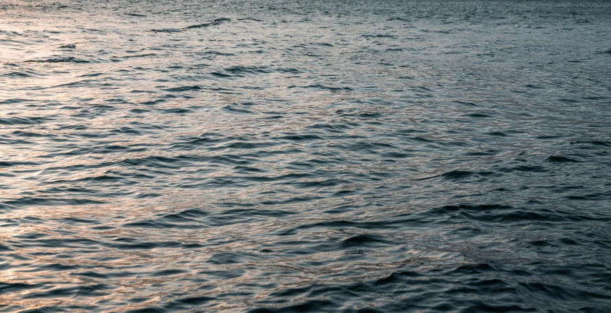 a large body of water with a boat in the distance, inspired by Elsa Bleda, hurufiyya, swirly ripples, evening sun, 8k 50mm iso 10, shot on hasselblad