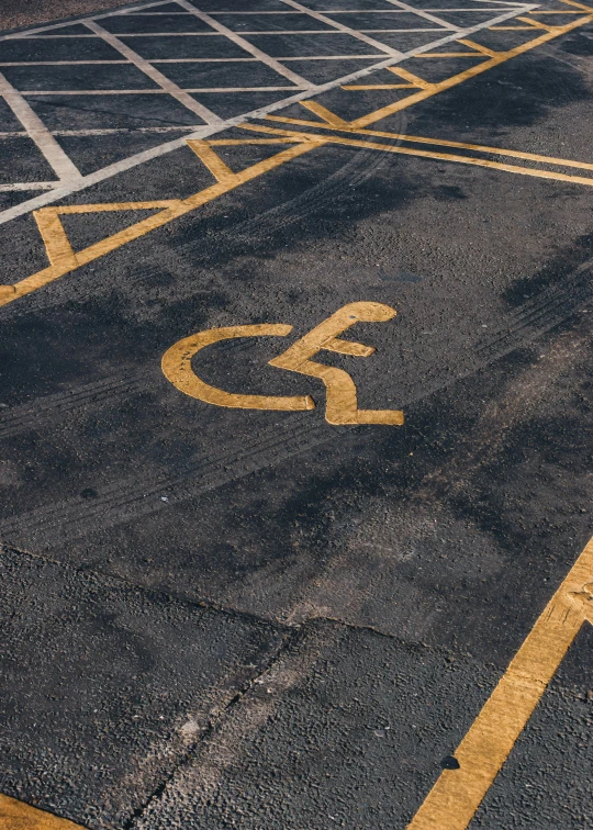 a parking lot with a handicap sign painted on it, an album cover, trending on unsplash, auto-destructive art, paul barson, square, high quality photo, gold