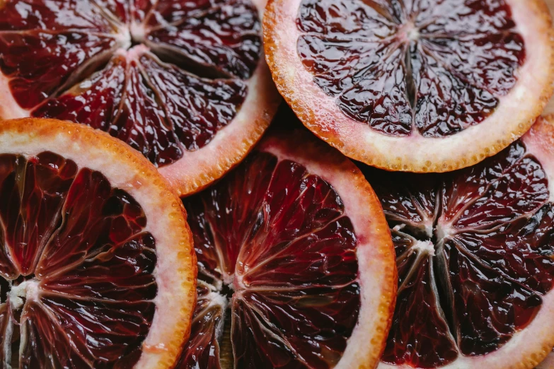 a pile of blood oranges cut in half, by Carey Morris, trending on pexels, process art, purple, eyes wide opened, 🦩🪐🐞👩🏻🦳, alex from a clockwork orange