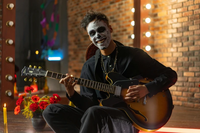 a man sitting on the ground playing a guitar, pexels contest winner, vanitas, joker makeup, avatar image, smiling mask, halloween scene