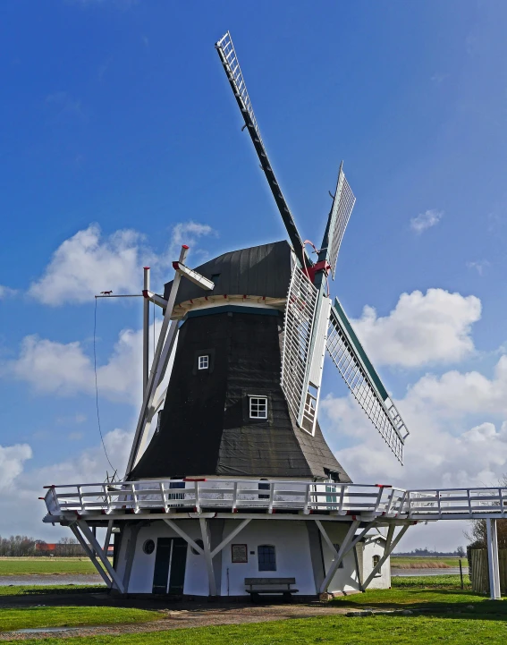 a windmill sitting on top of a lush green field, by Michiel van Musscher, multiple stories, blue skies, square, sakimichan