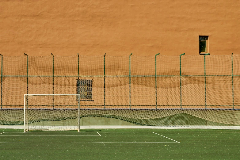 a soccer goal sitting on top of a green field, a picture, inspired by Hans Mertens, pexels contest winner, beach tennis, ocher, alessio albi, 15081959 21121991 01012000 4k