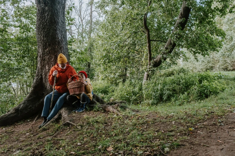 a man and a woman sitting under a tree, by Emma Andijewska, pexels contest winner, lumberjack, 2 5 6 x 2 5 6 pixels, red riding hood, food. craft and adventure