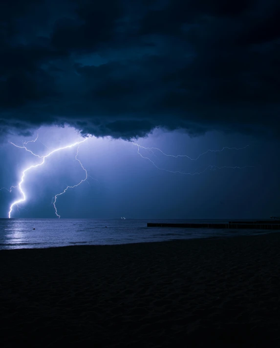 a lightning bolt in the sky over a beach, by Adriaen Hanneman, pexels contest winner, bisexual lighting, looking threatening, ☁🌪🌙👩🏾, powerful scene