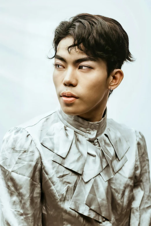 a close up of a person wearing a jacket, inspired by Tadashi Nakayama, trending on pexels, rococo, boyish face, shiny silver, ethnicity : japanese, kpop