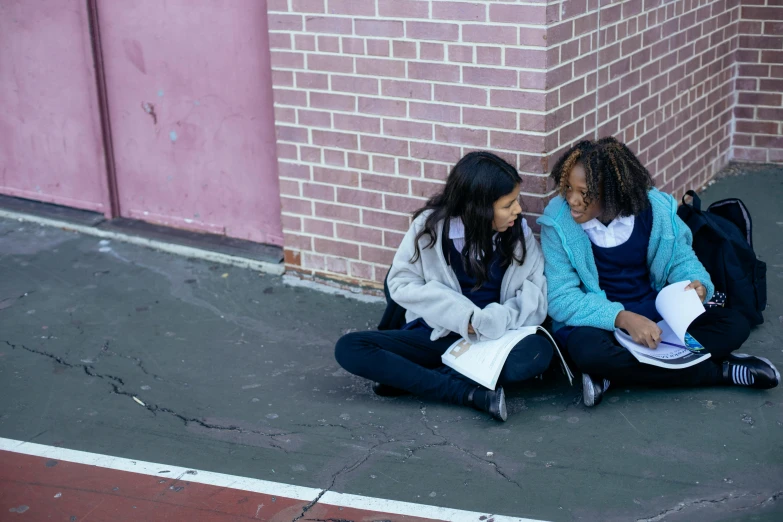 two girls sitting on the ground reading books, trending on unsplash, ashcan school, black teenage girl, scene from live action movie, blank, photographed for reuters